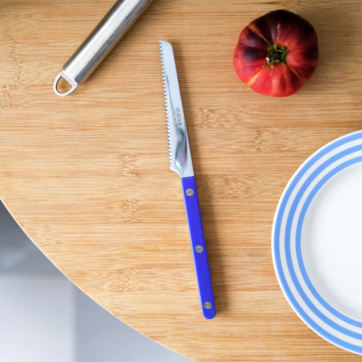 Lapis Blue Sabre Paris Bistrot French Tomato Knife on wood table with plate