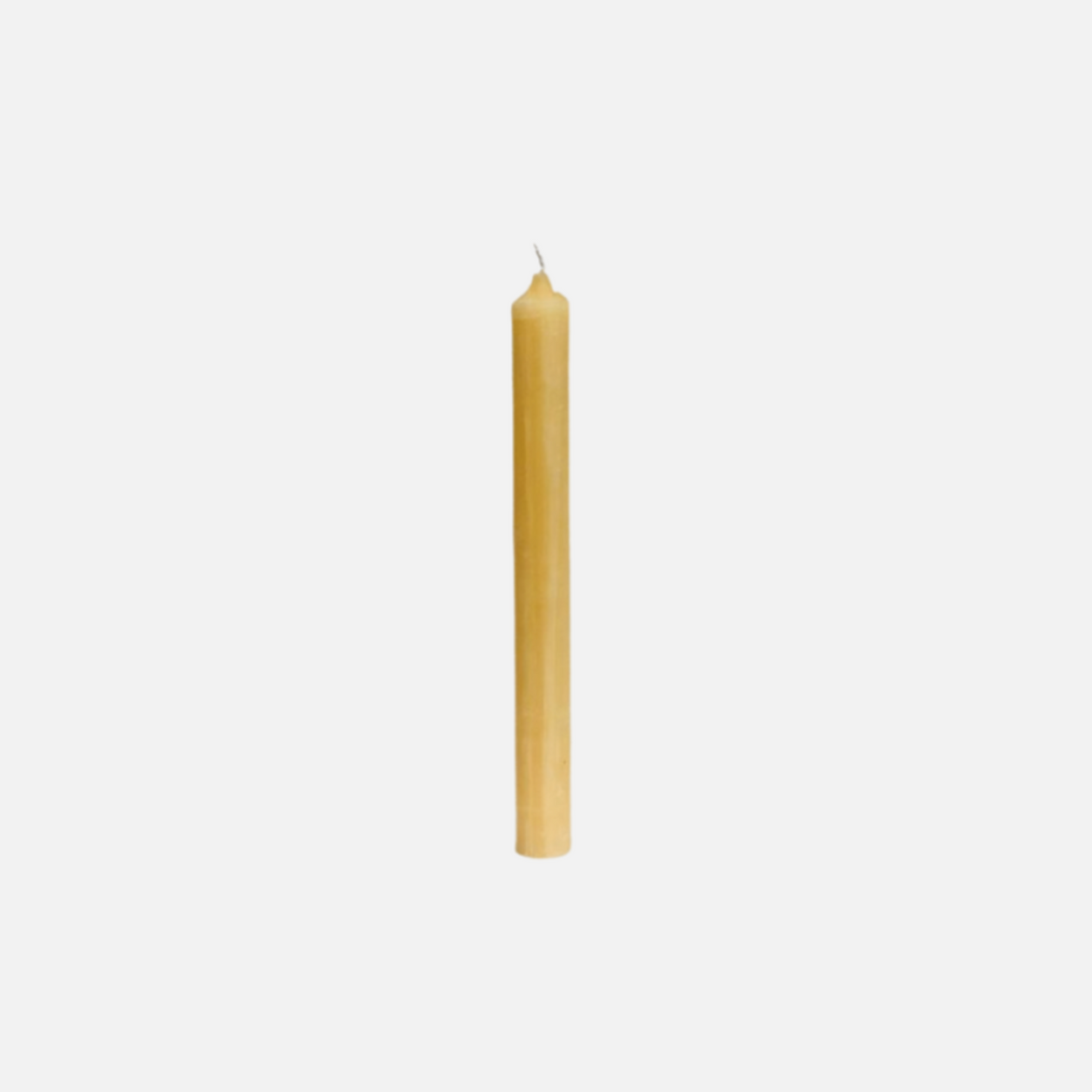 Single yellow candle on a light gray background