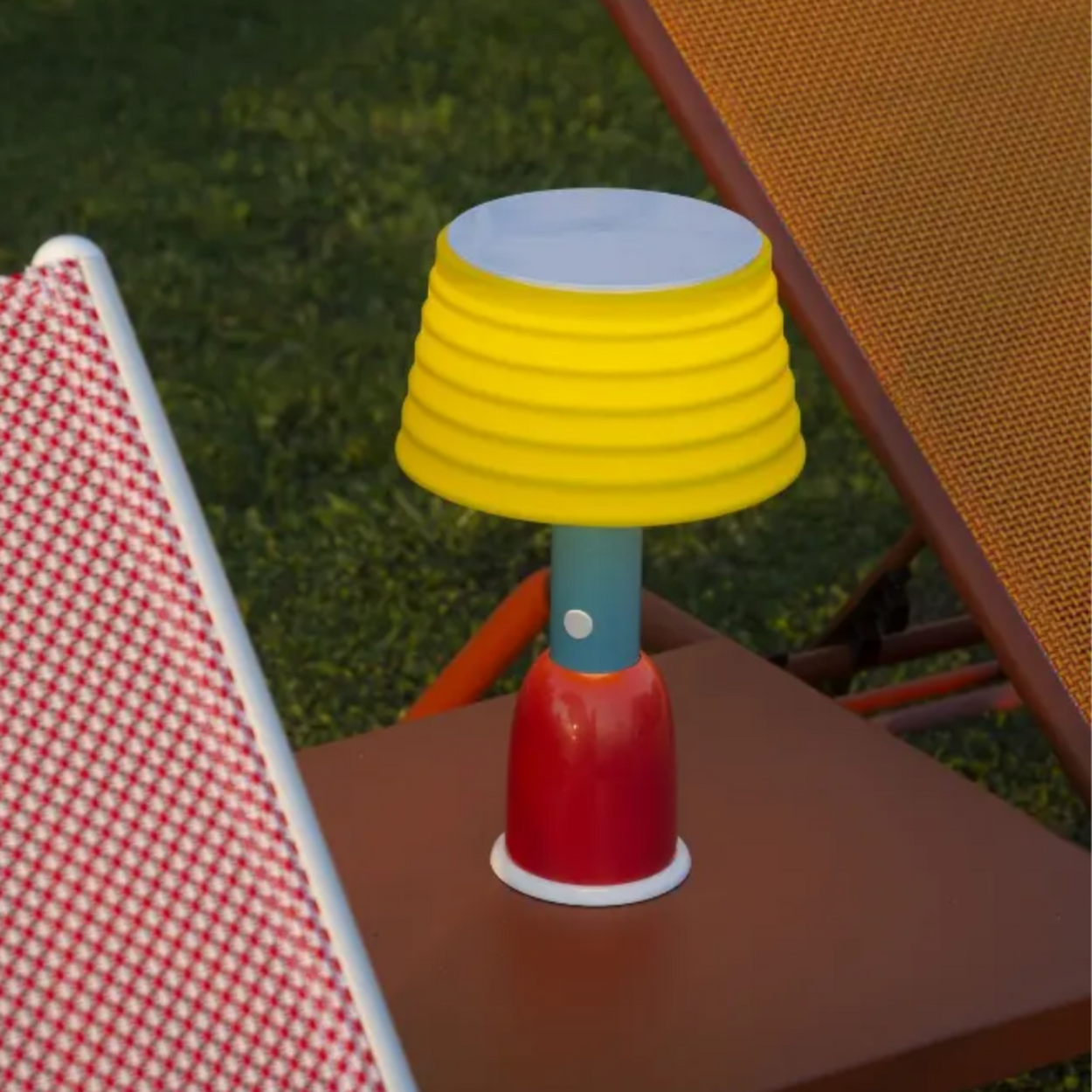 Colorful outdoor lamp on a table with grass in the background