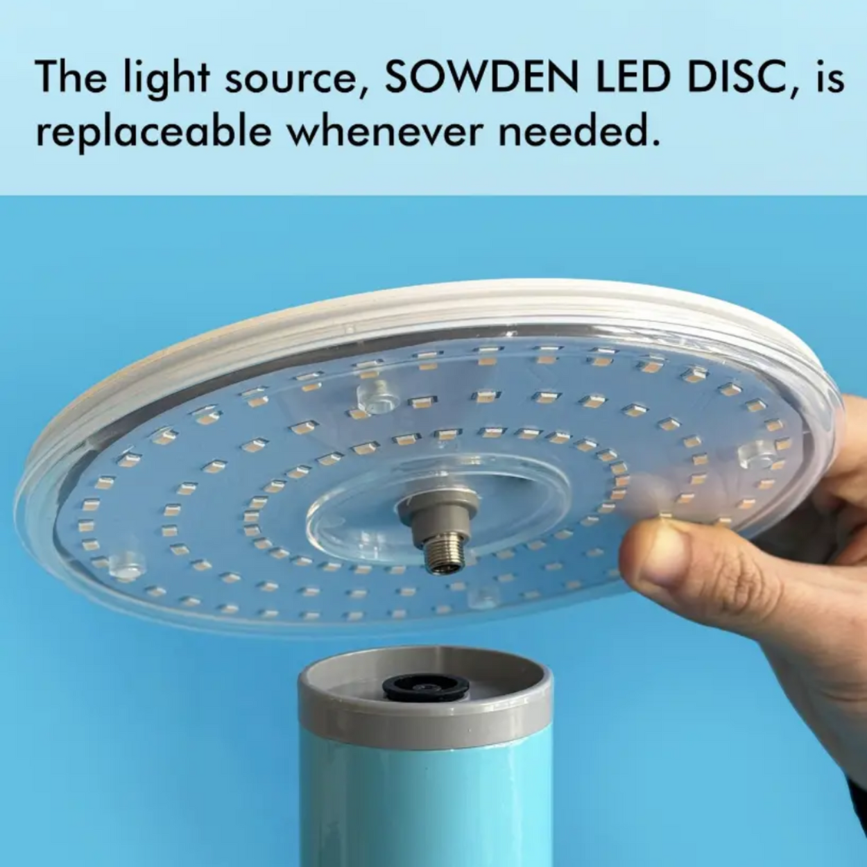 SOWDEN LED DISC light source being held above a cylindrical device with blue background