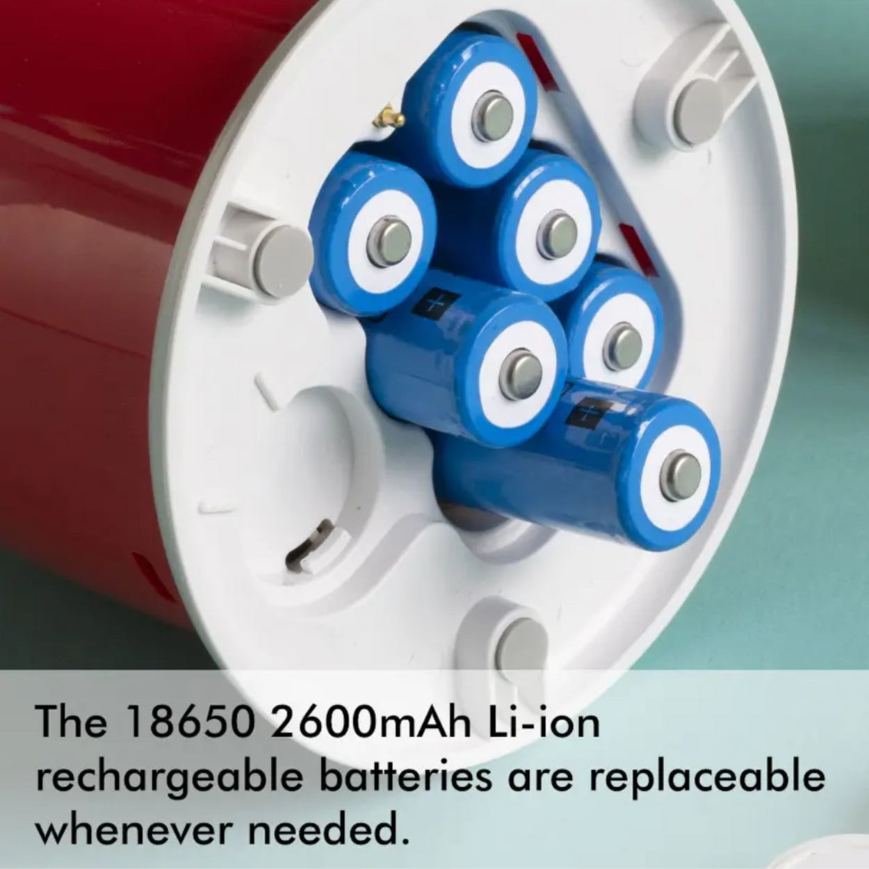 Close-up of a battery pack with blue and white cylindrical batteries on a red and white reel.