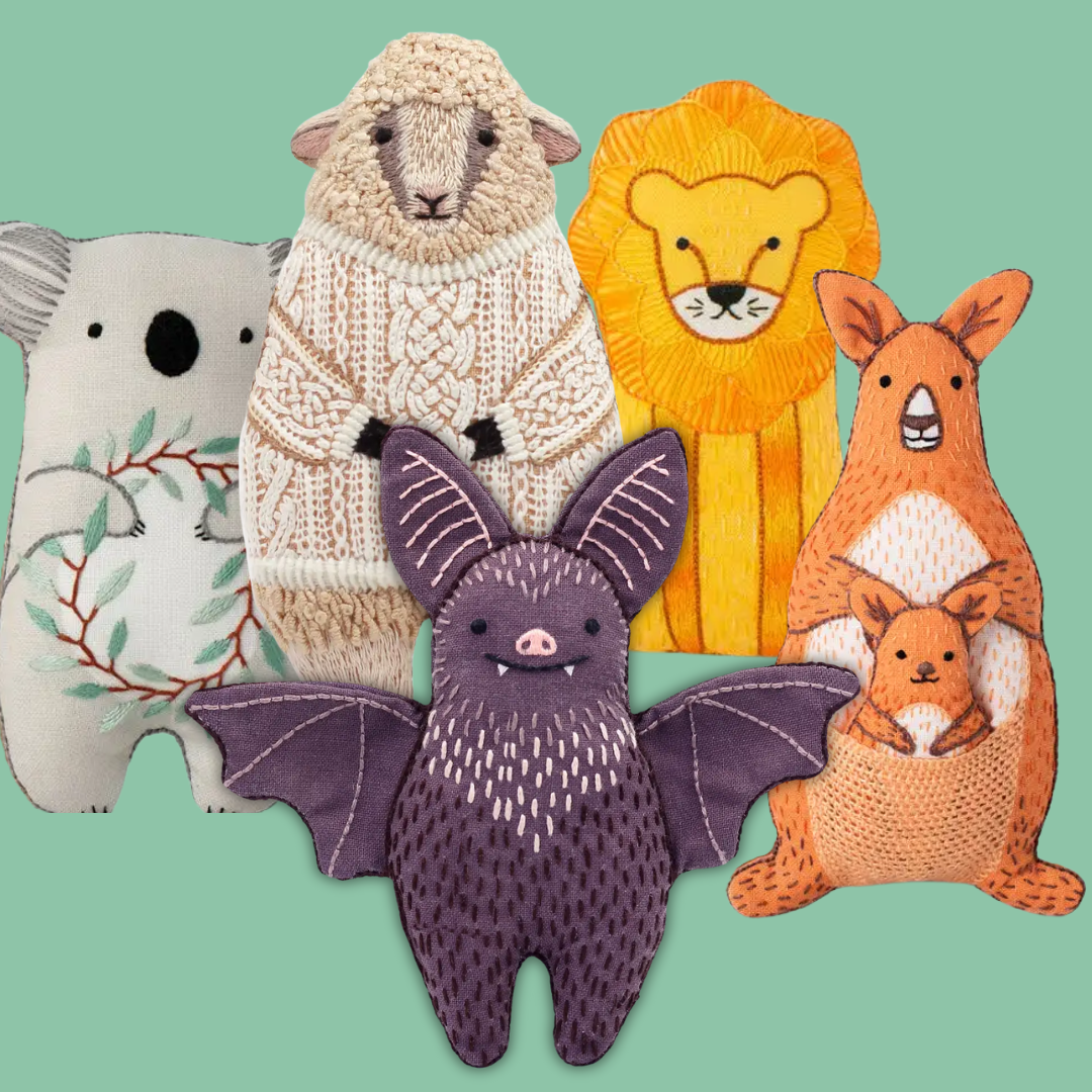 Collection of colorful animal plush toys on a green background