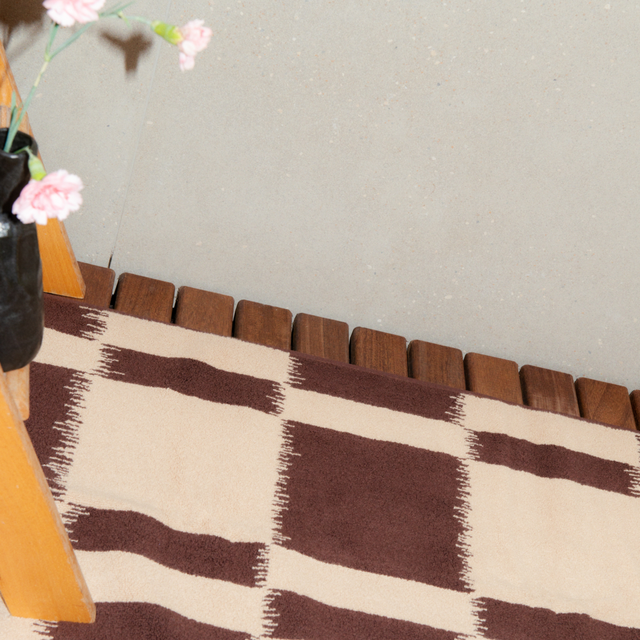 Autumn Sonata Karin Bath Mat flat lay on wood slat floor