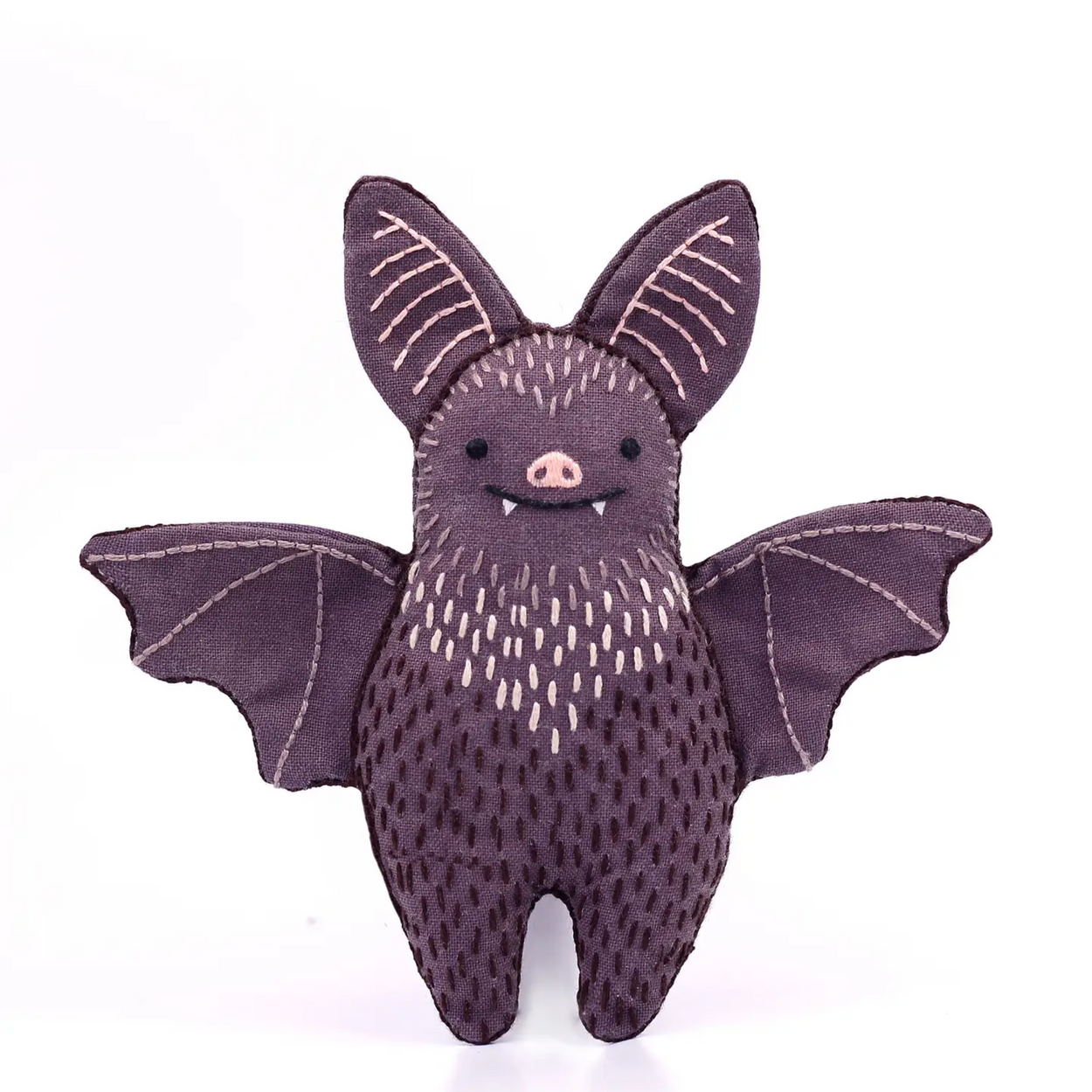 Stuffed bat toy with purple fur on a white background