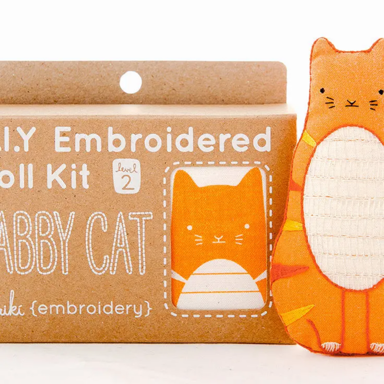 Embroidered toy kit with a cat design and packaging on a white background
