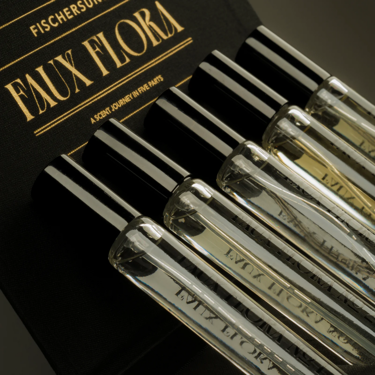 Set of Fischersuppe Faux Flora perfume bottles with a black box in the background.