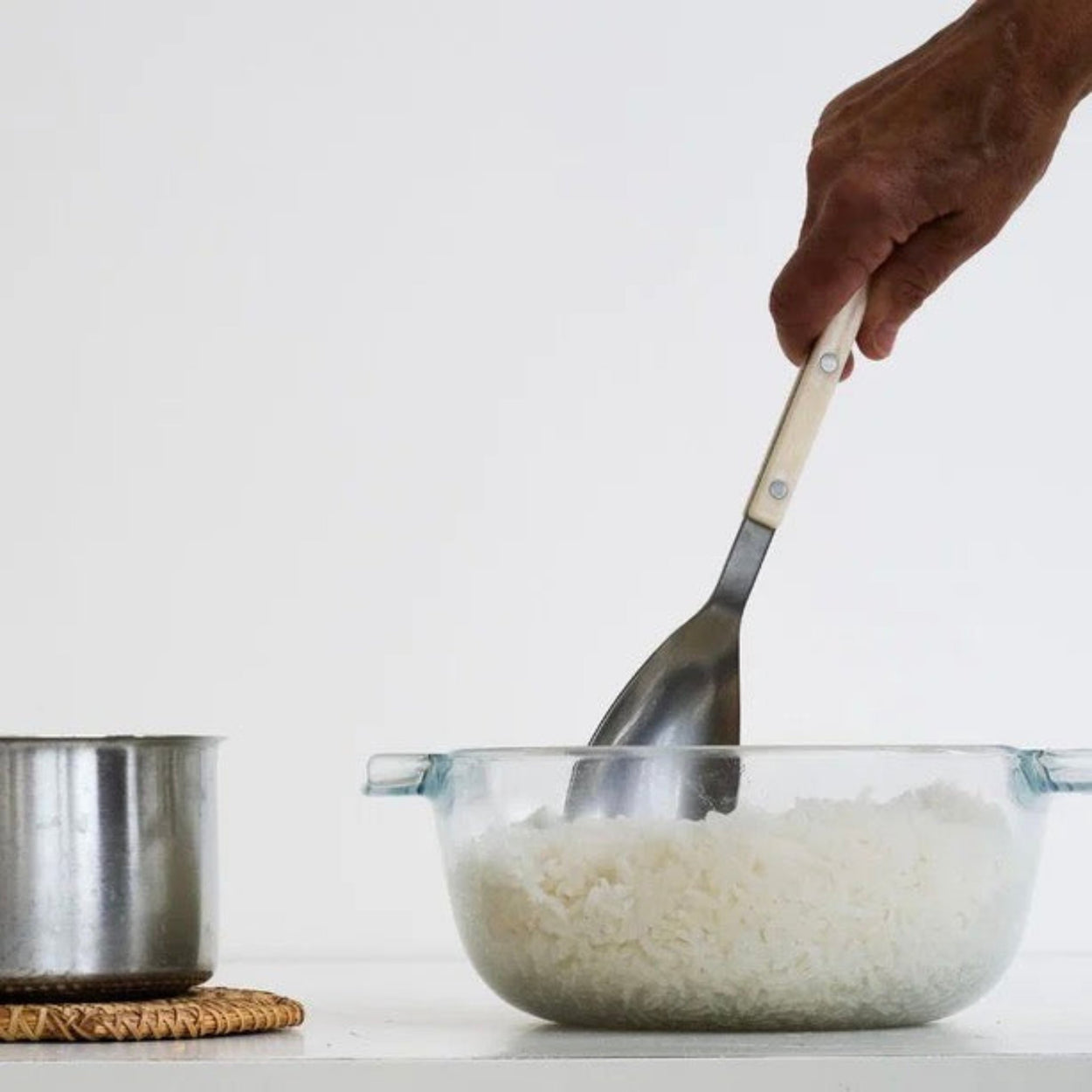 Person holding white Sabre Paris Bistrot Rice Spoon, in dish of rice