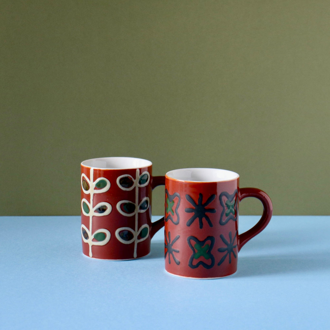Vintage ceramic cups with blue green background