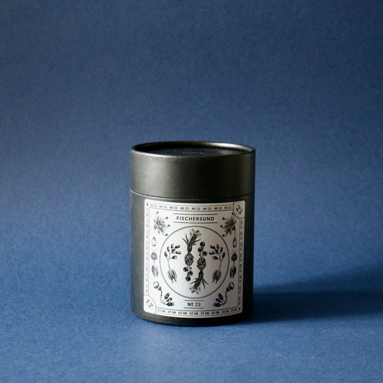 Fischersund No.23 candle with tube packaging against blue background.