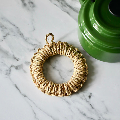 Japanese Woven Pot Holder on marble bench with green Amu kettle.