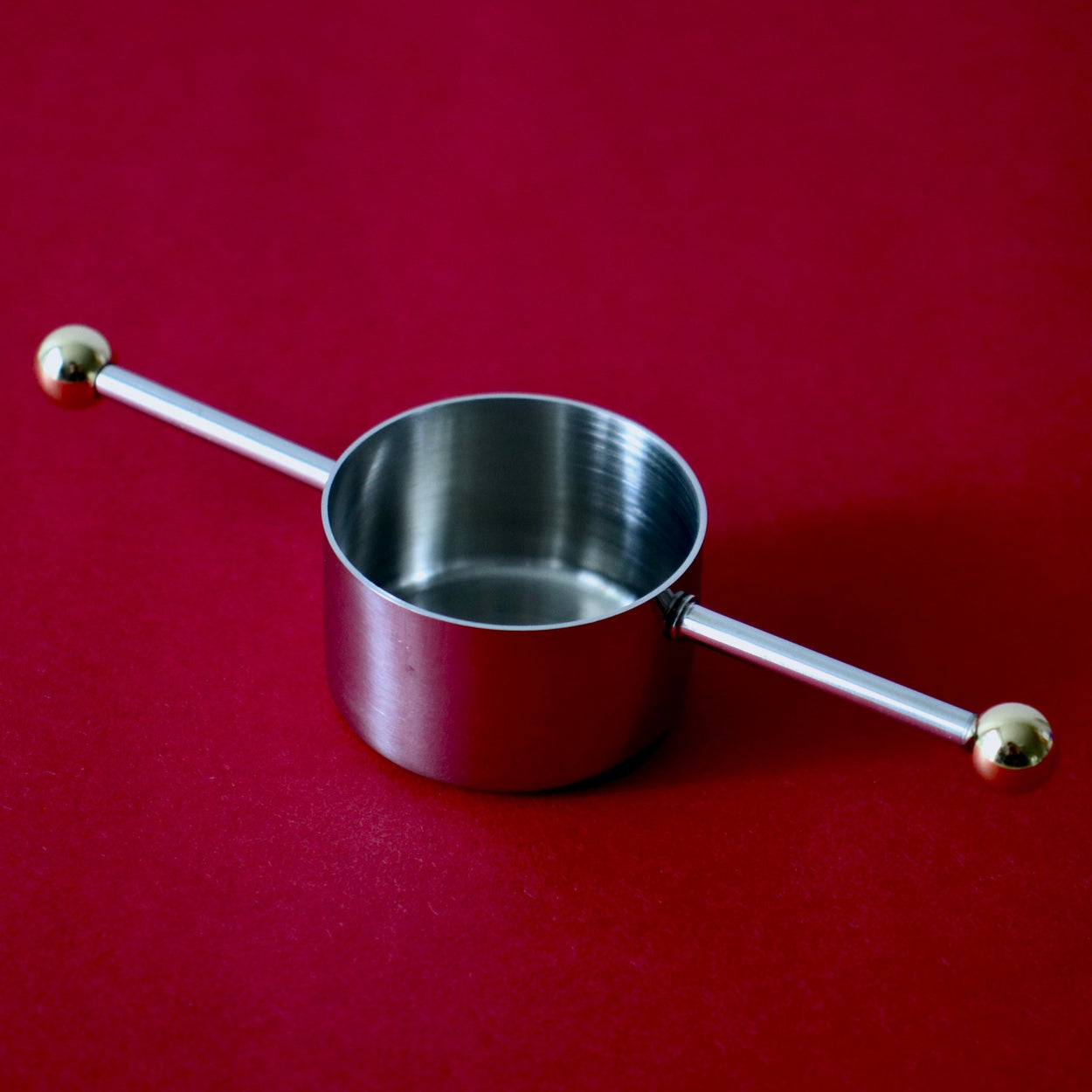 Japanese Cocktail Jigger against a red backdrop.