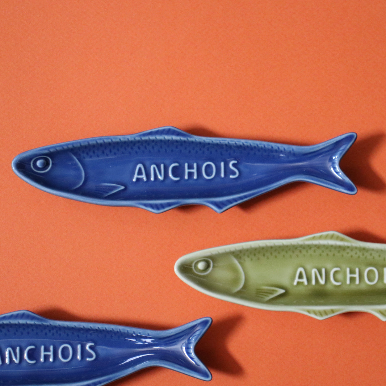 Blue and olive Fisherman's sardine plates close up