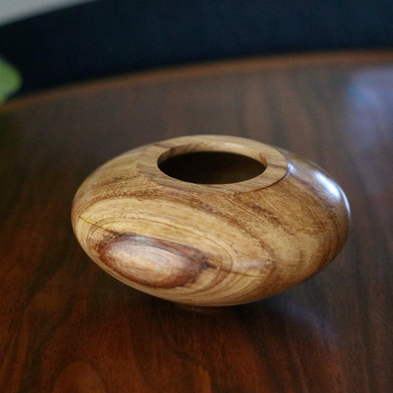 Vintage wood low vase on wood table.