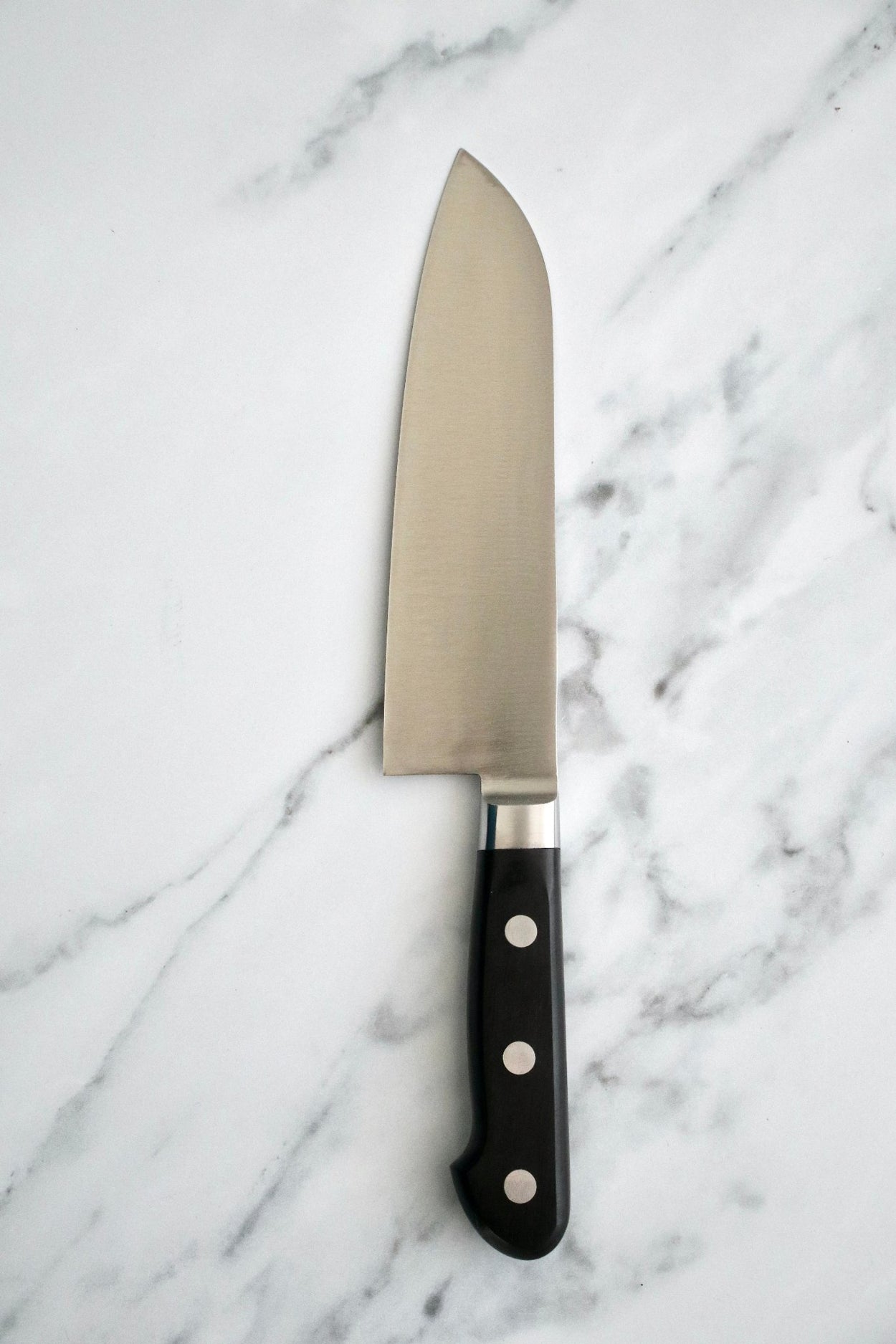 Japanese Naozumi Nihonkou 165mm Santoku Carbon Steel Kitchen Knife on marble background.