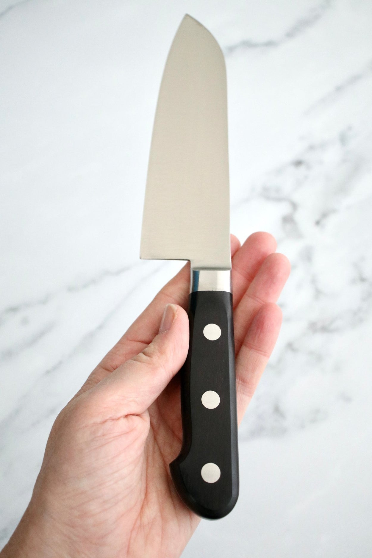 Japanese Naozumi Nihonkou 165mm Santoku Carbon Steel Kitchen Knife on marble background.