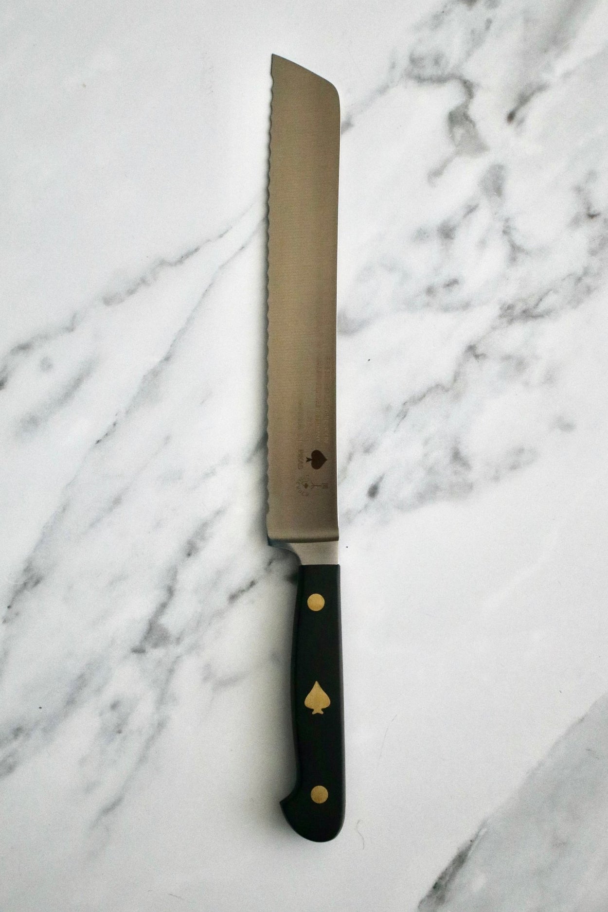Friedr Herder Pikas 20cm Bread Knife on marble bench.