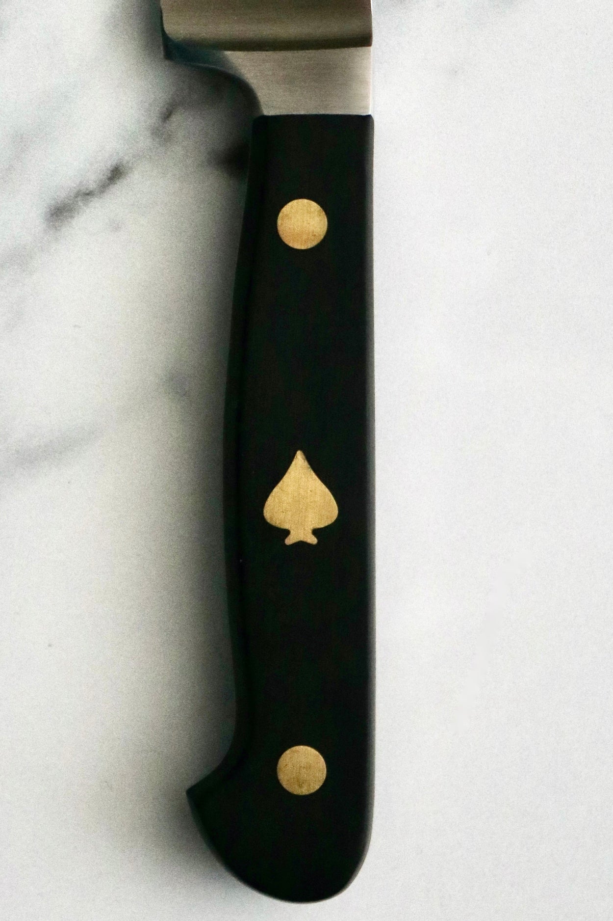 Friedr Herder Pikas 20cm Bread Knife close up, on marble bench.