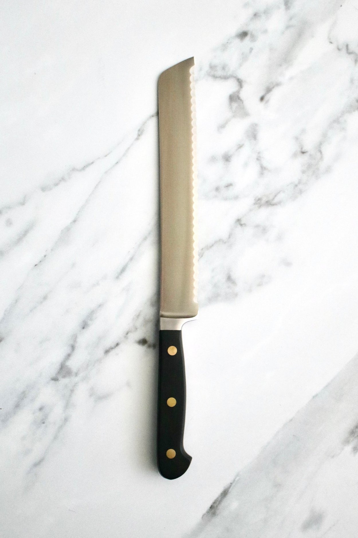 Friedr Herder Pikas 20cm Bread Knife on marble bench.