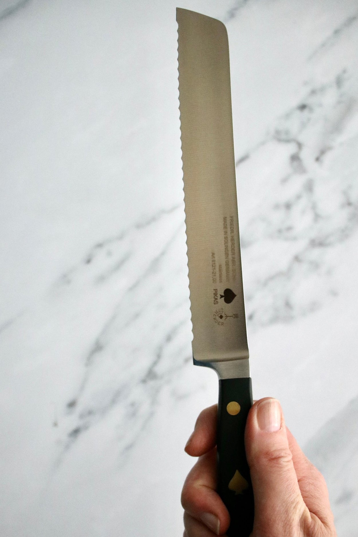 Friedr Herder Pikas 20cm Bread Knife on marble bench.