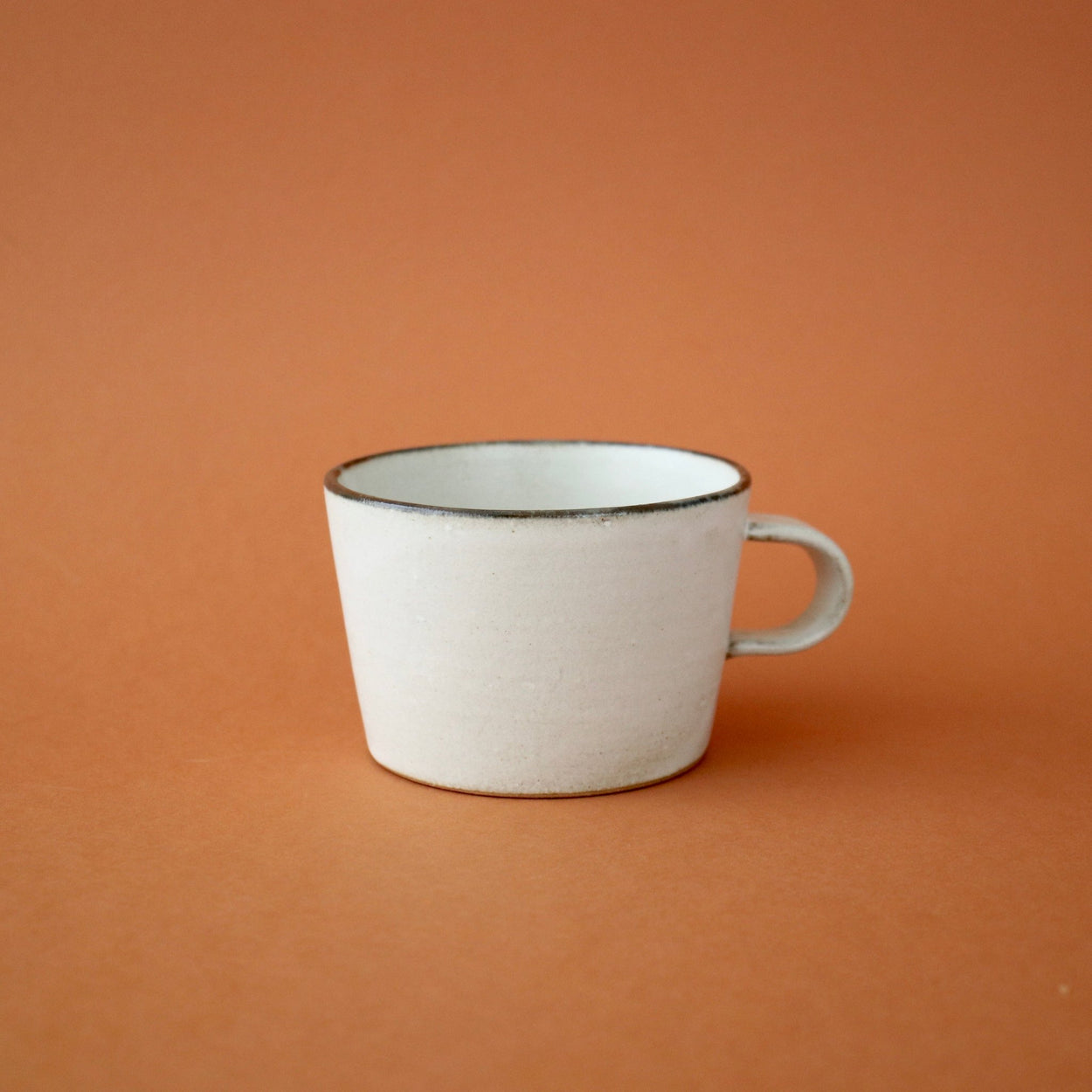 Japanese Ceramic Birch Cup against orange backdrop.