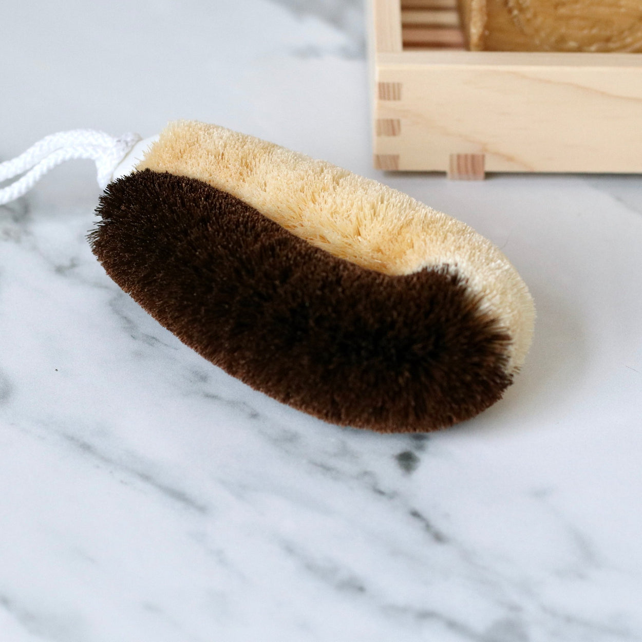 Japanese two toned natural body scrub brush on marble bench