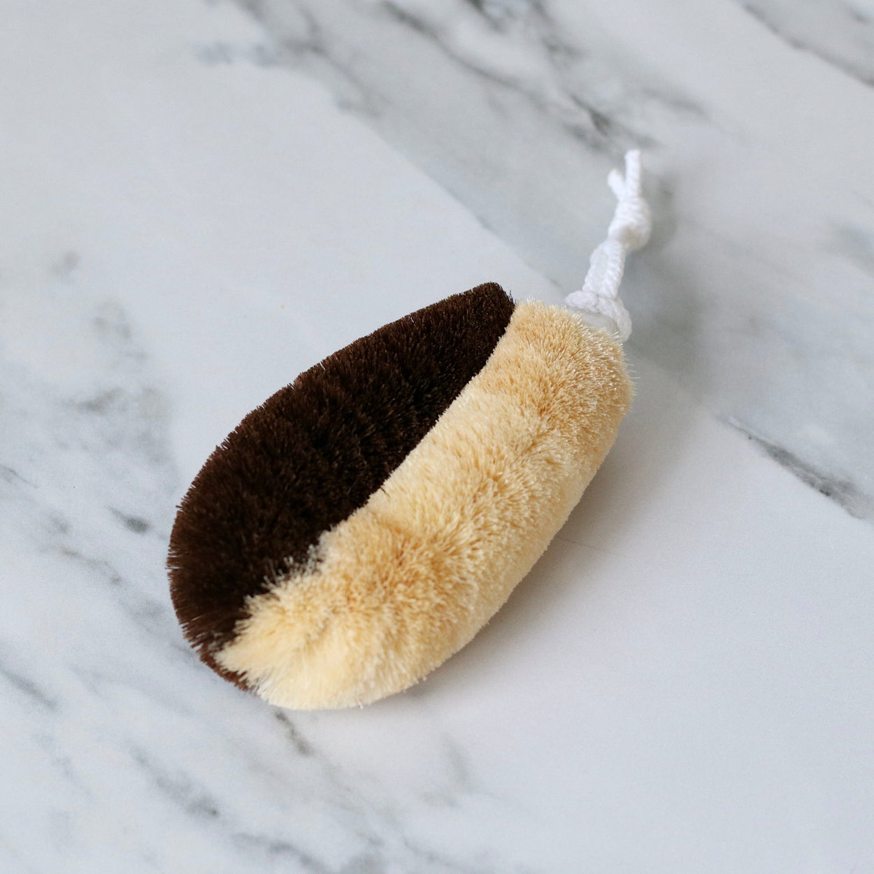 Japanese two toned natural body scrub brush on marble benchtop