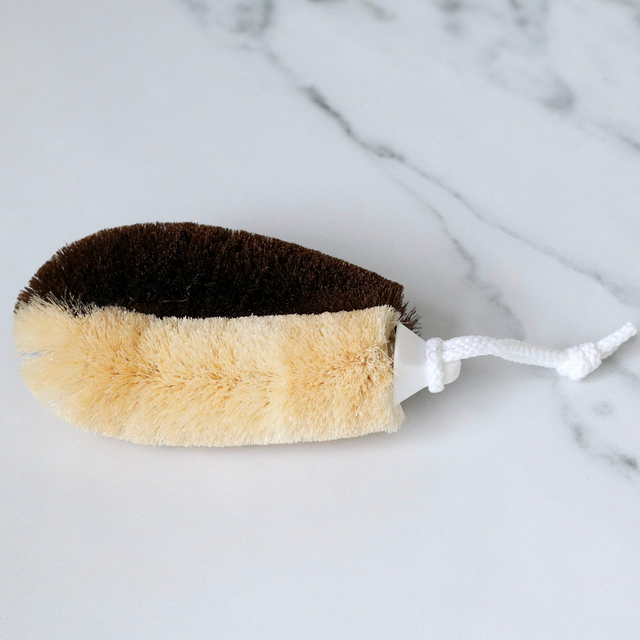Japanese two toned natural body scrub brush on marble benchtop