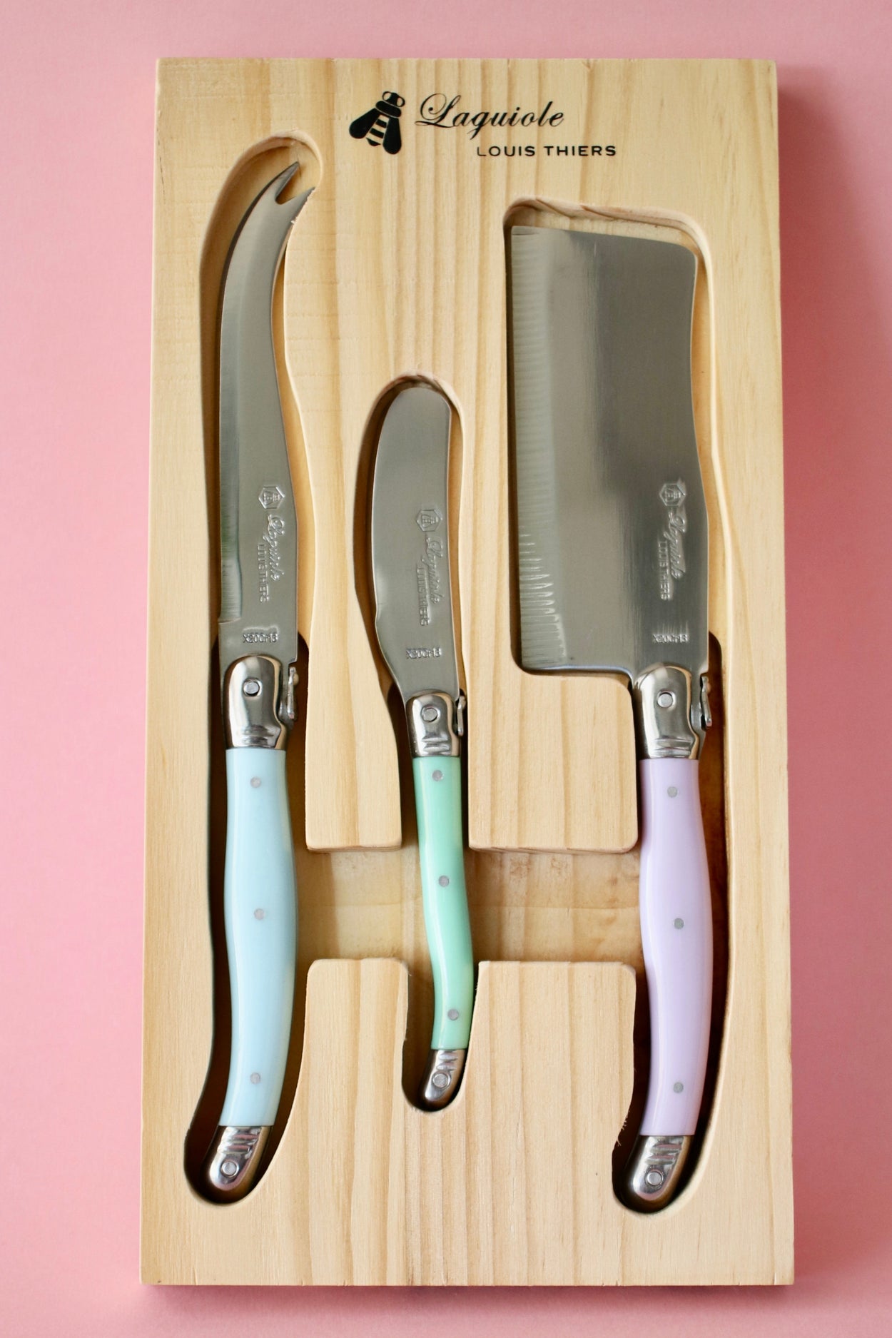 Vintage Laguiole Cheese serving set against pink background