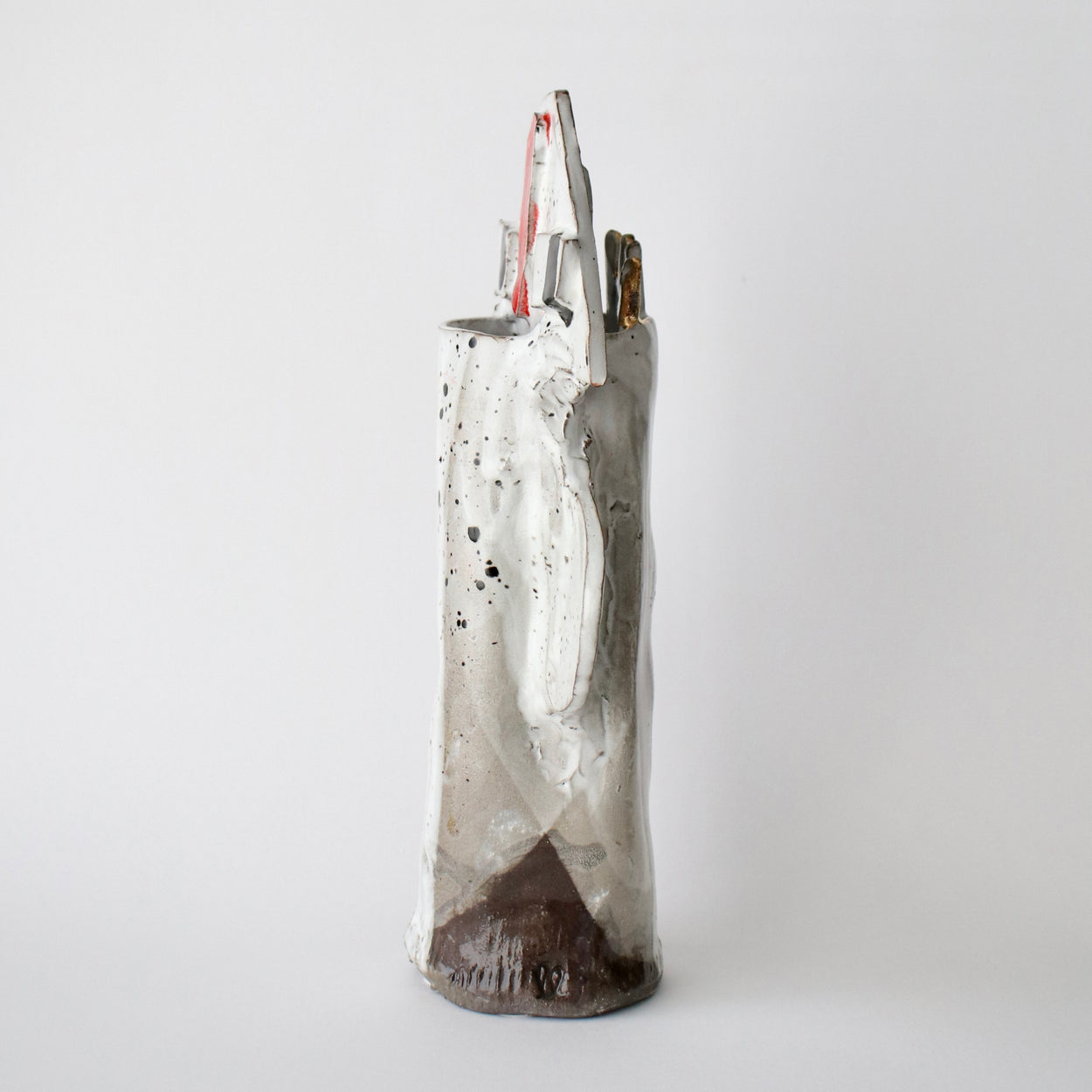Ceramic vase with speckled design on a white background