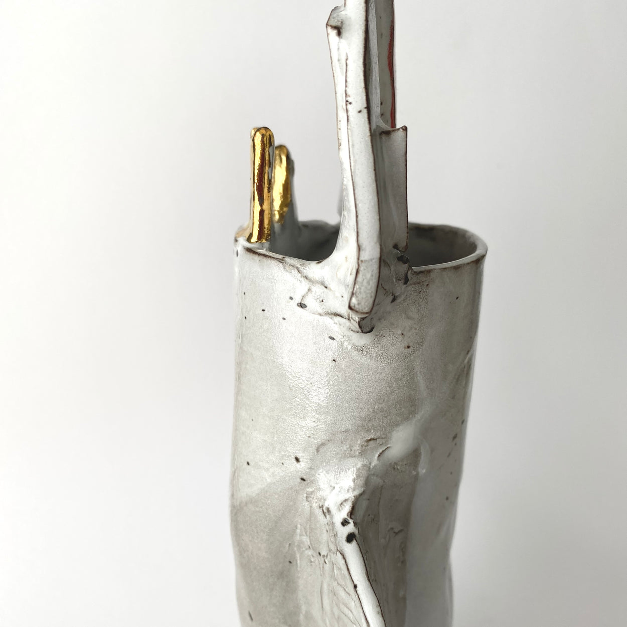 Silver vase with gold accent on a white background