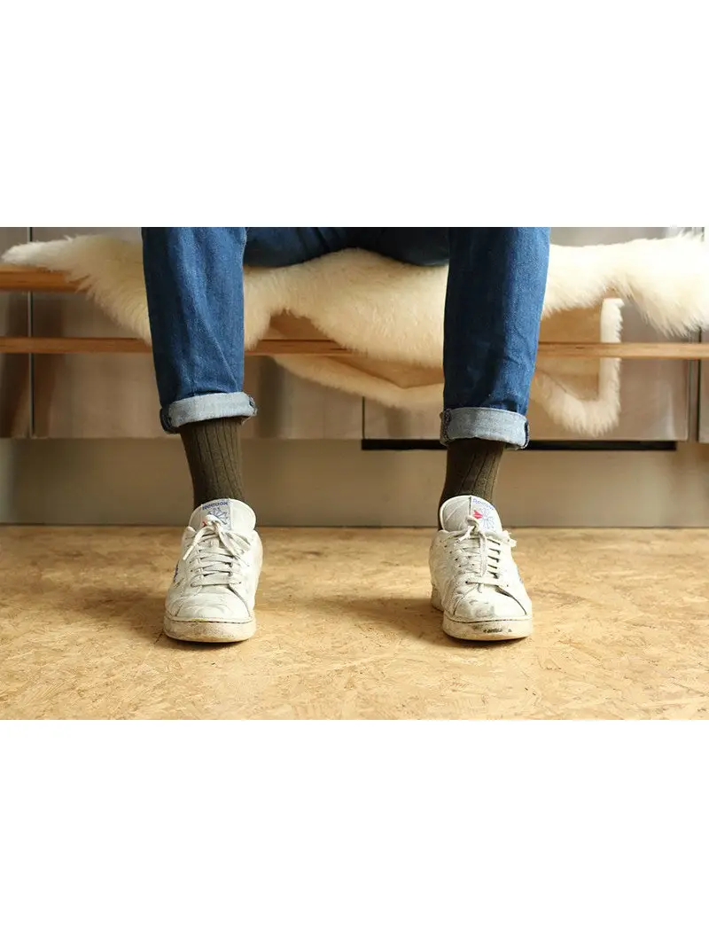 Man in jeans wearing khaki green Escuyer Cashmere Wool Socks
