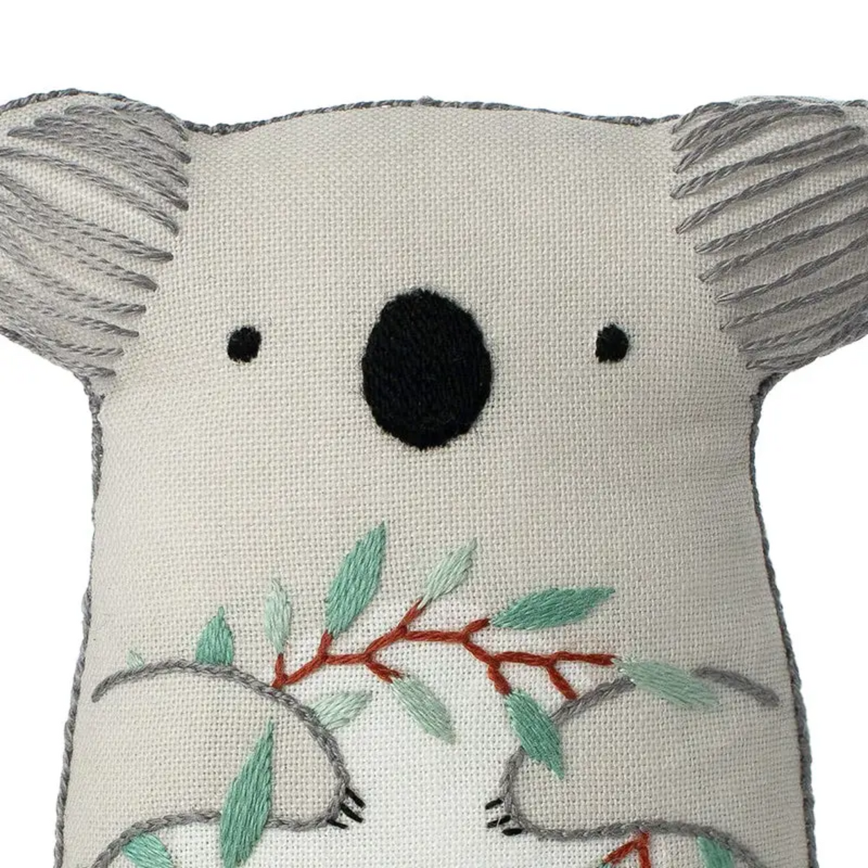 Embroidered koala plushie with leaves on a white background
