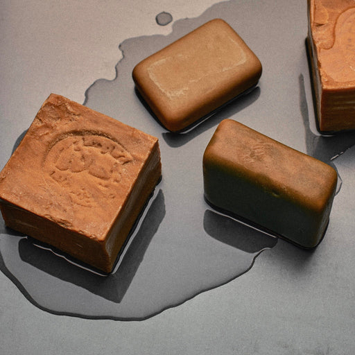 Alepp soap bars on grey background with water
