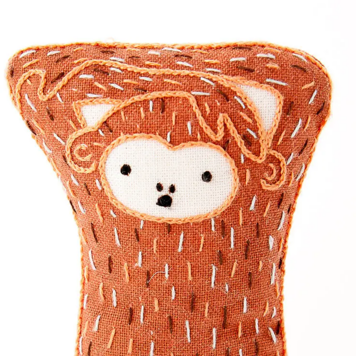 Textile product with a bear face design on an orange background