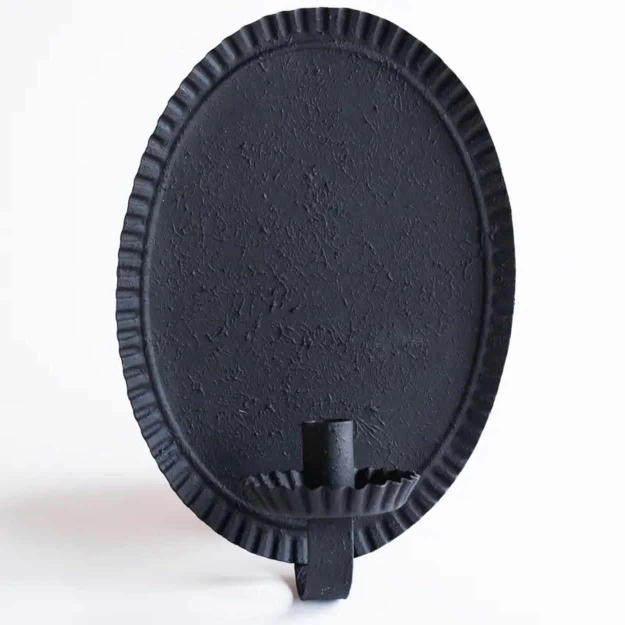 Oval candle sconce against grey background