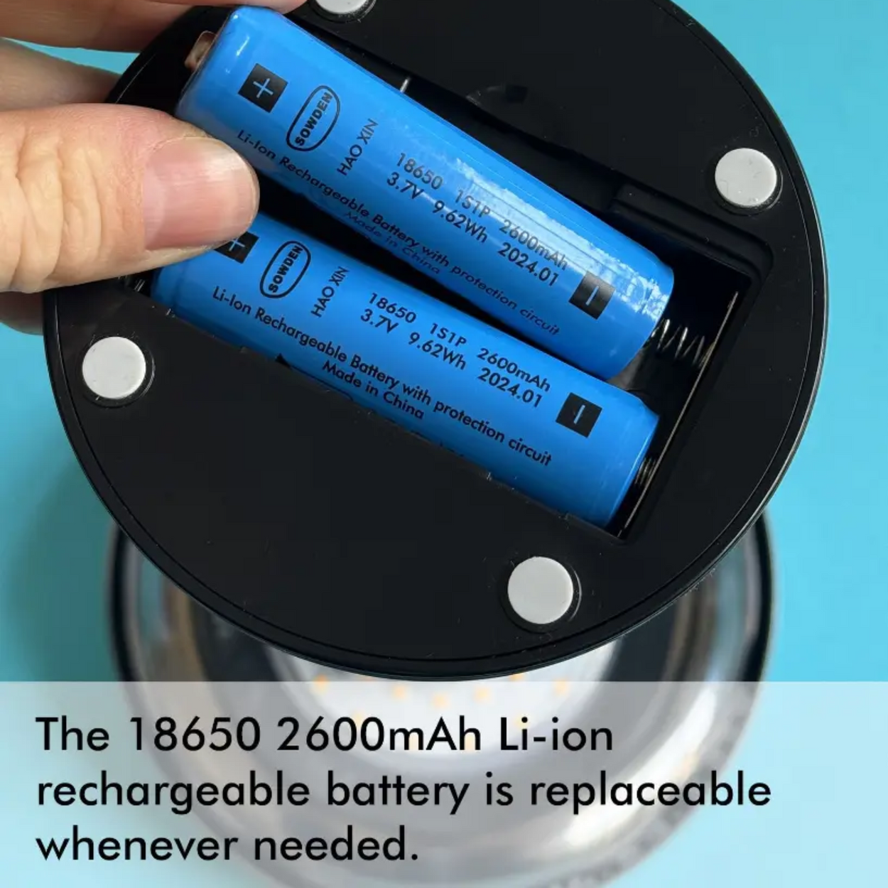 Hand holding a 18650 2600mAh Li-ion rechargeable battery with text on a blue background