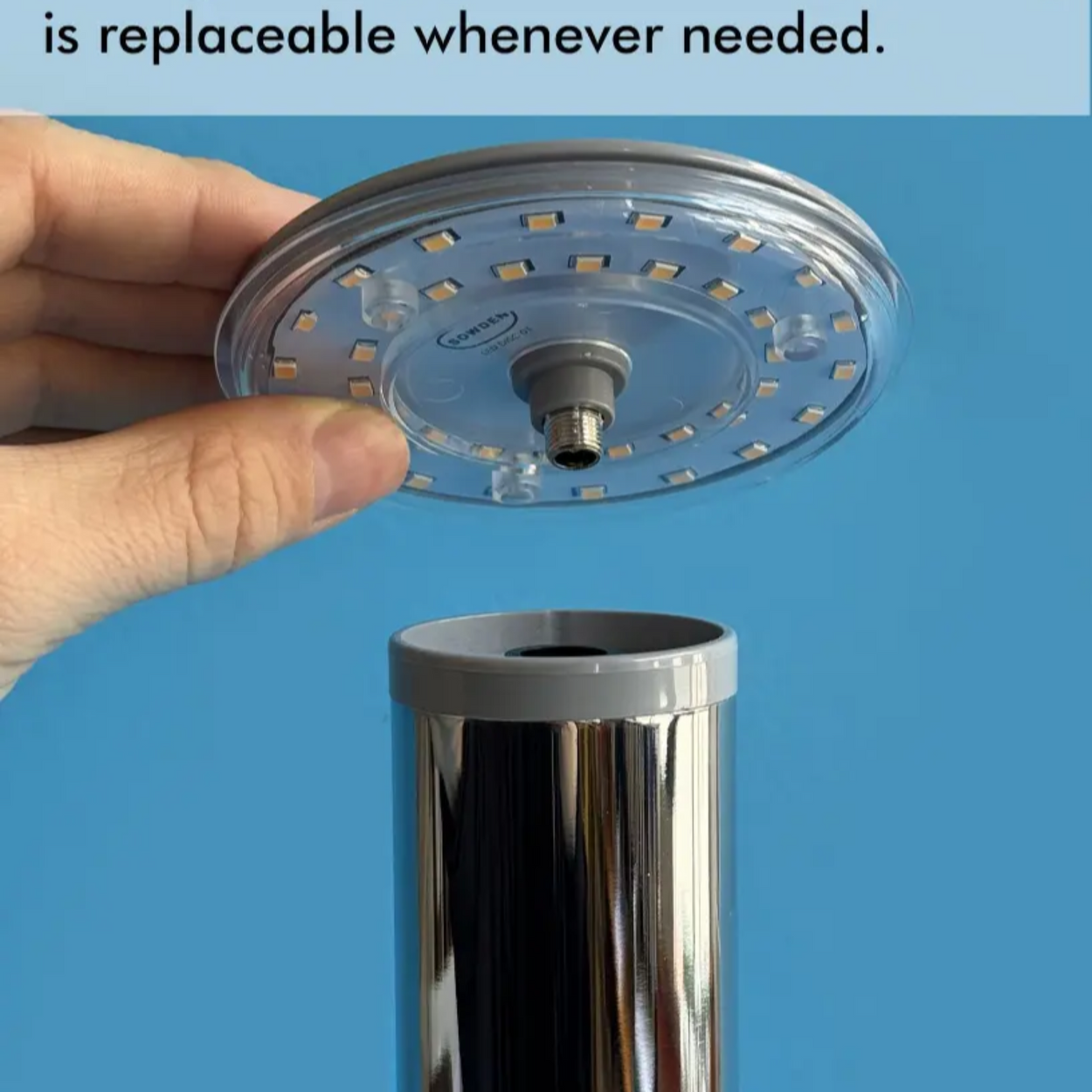 Hand holding a SOWDEN LED DISC against a blue background with text about replaceability.