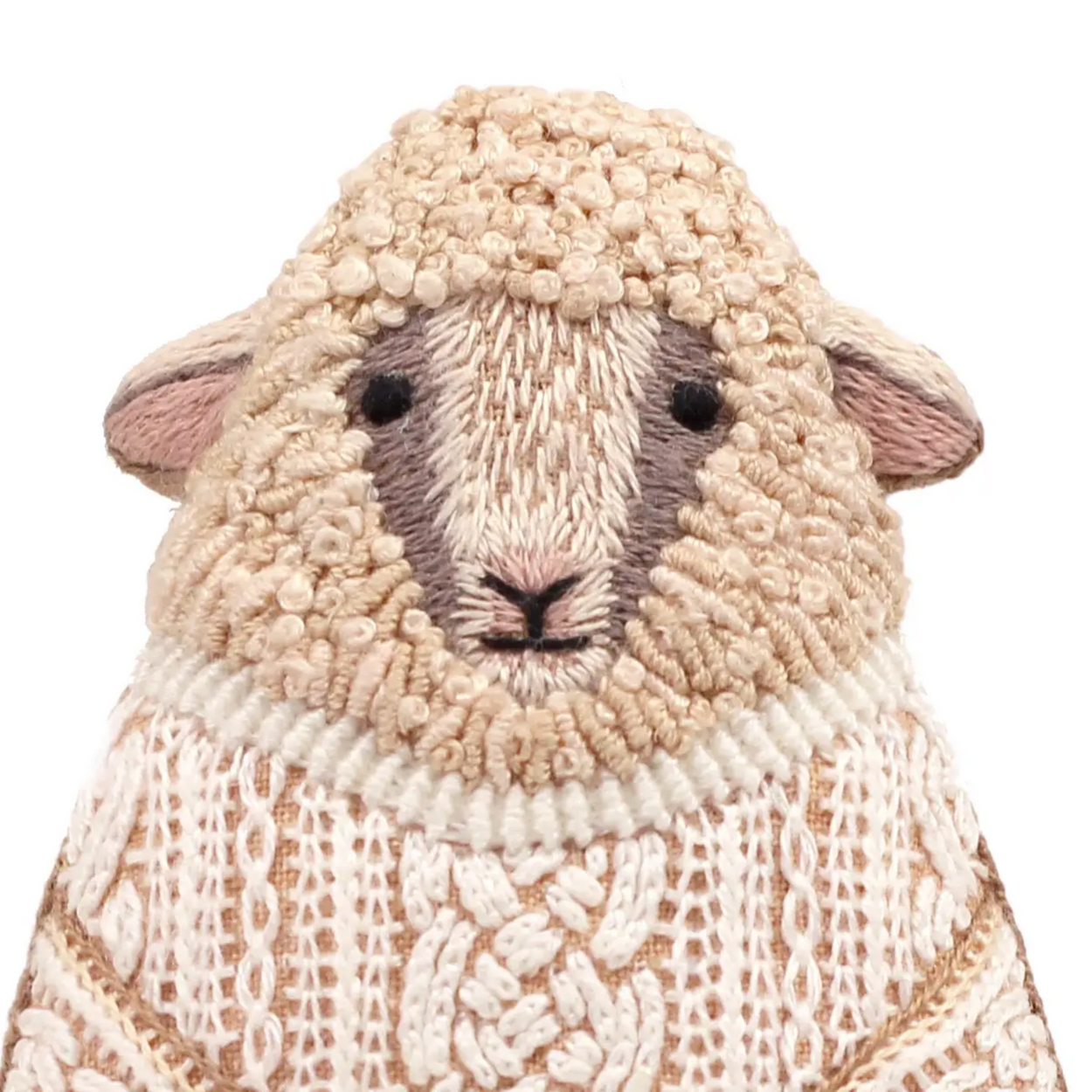 Textured sheep-shaped object with a knitted pattern on a white background