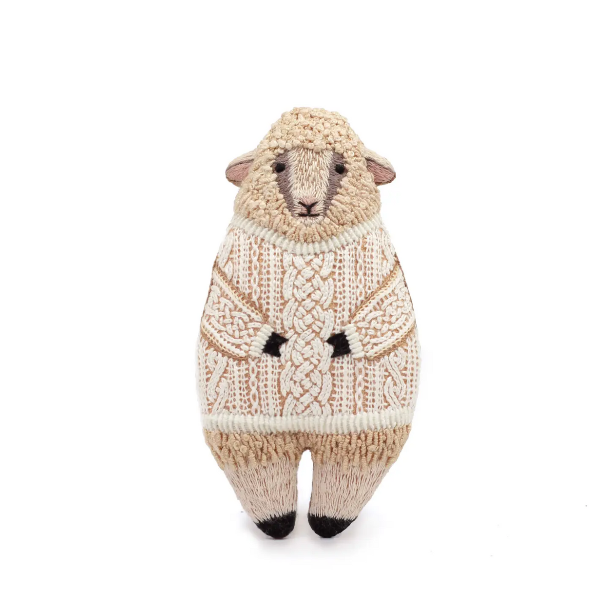 Knitted sheep toy wearing a sweater on a white background