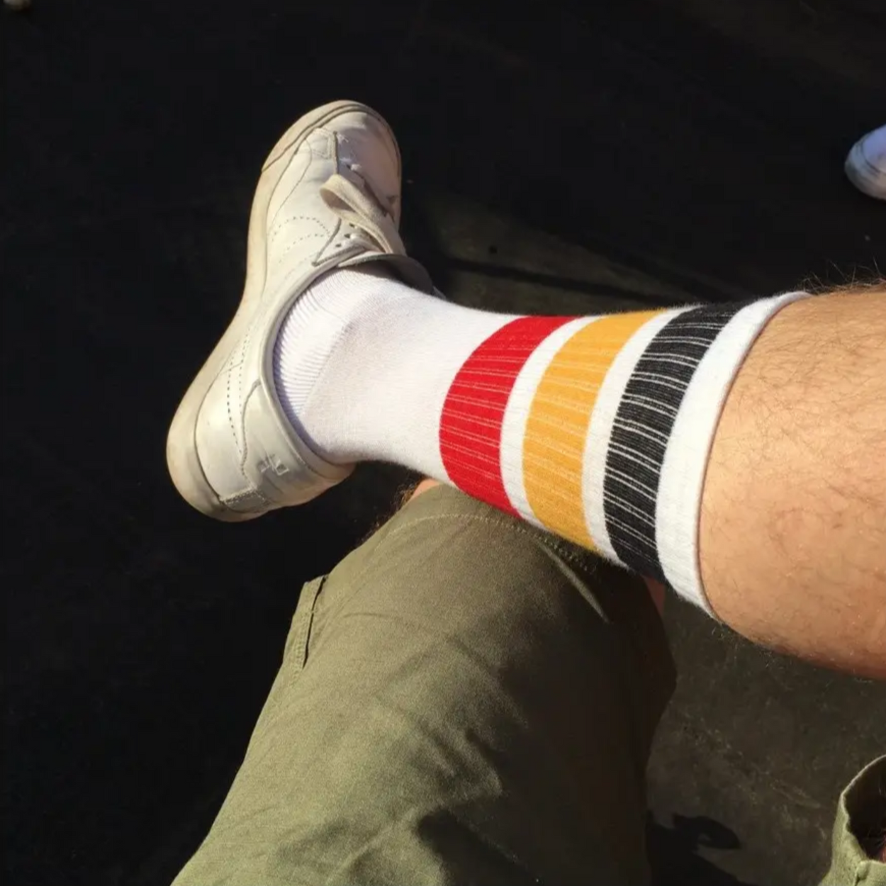 Escuyer stripe tube sock on mans leg with sneakers