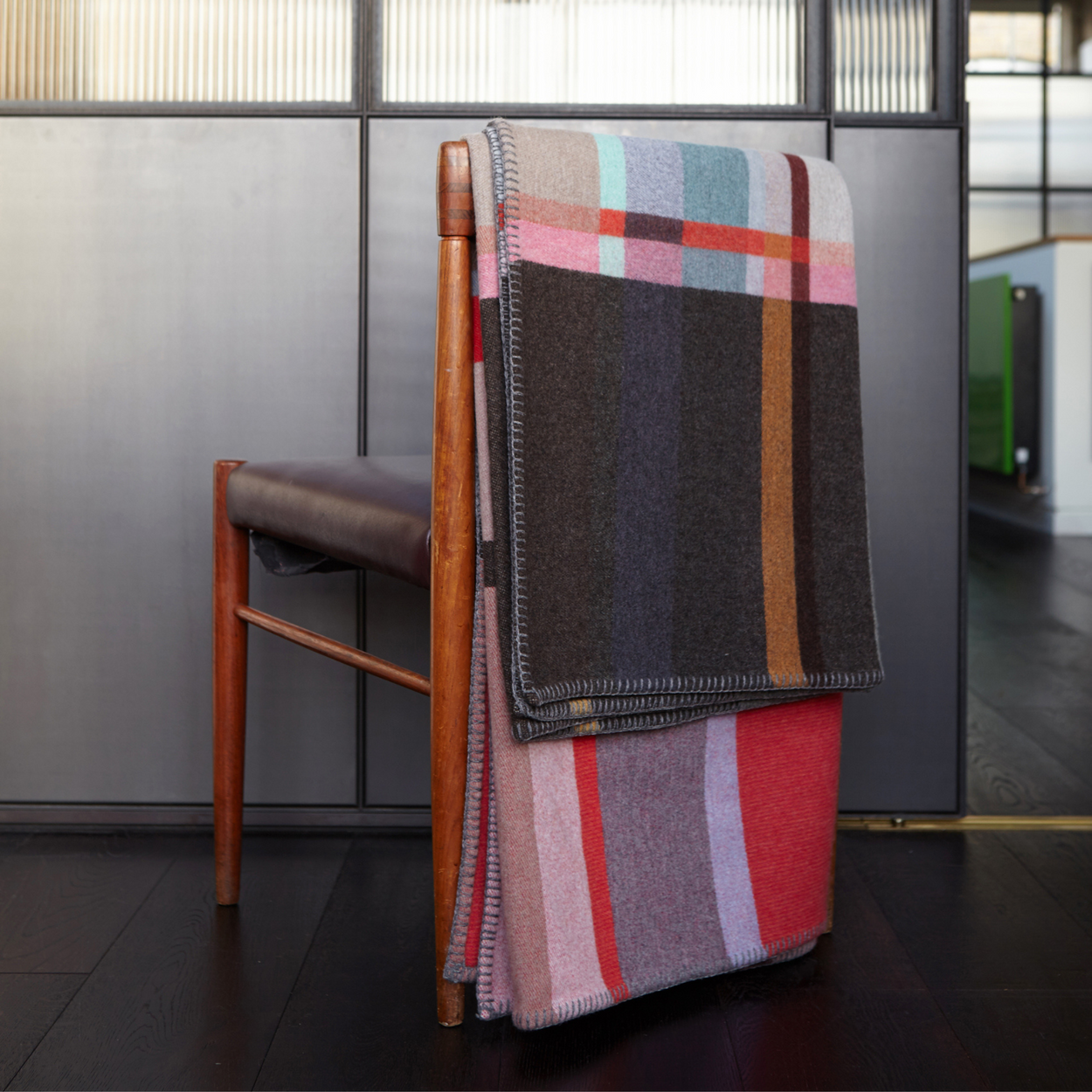 Wallace Sewell Premium Lasdun Merino Lambswool blanket folded on back of chair.