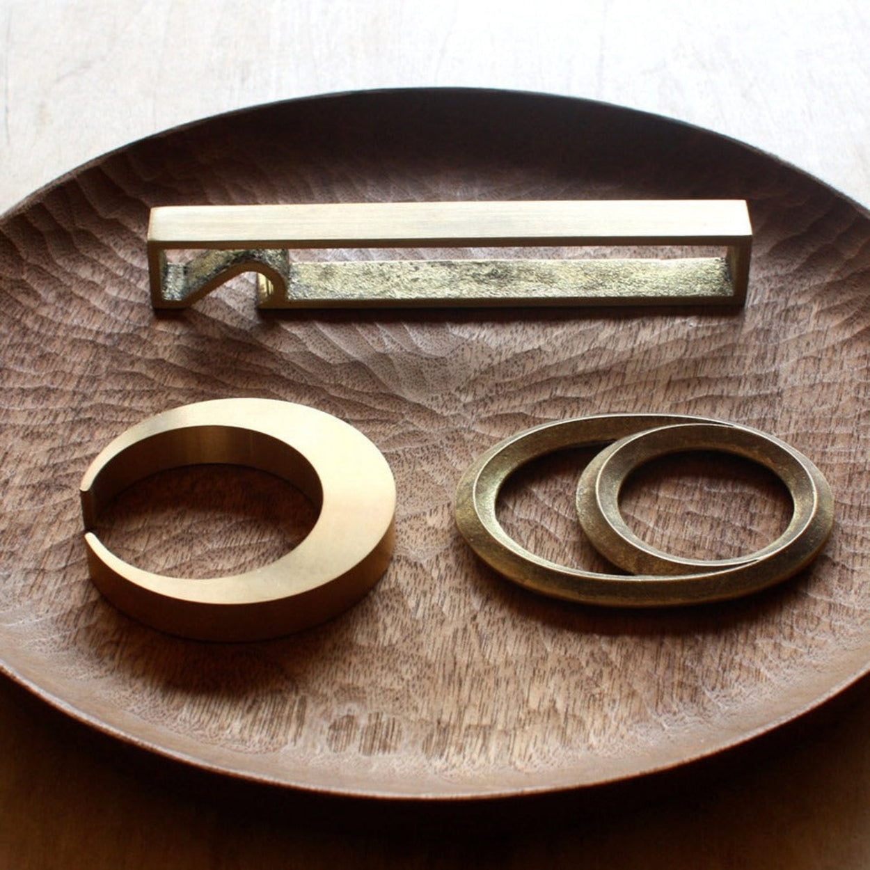 Futagami collection of Bottle Openers on wood bowl background.