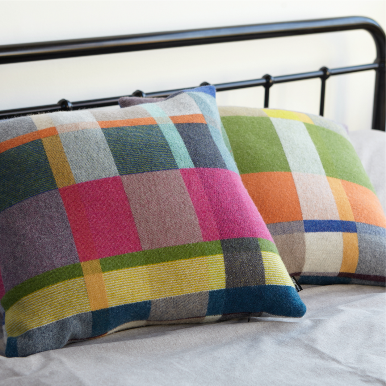 Two Premium Australian Merino Wool Cushion cover - Gwynne stuffed, on iron bed.