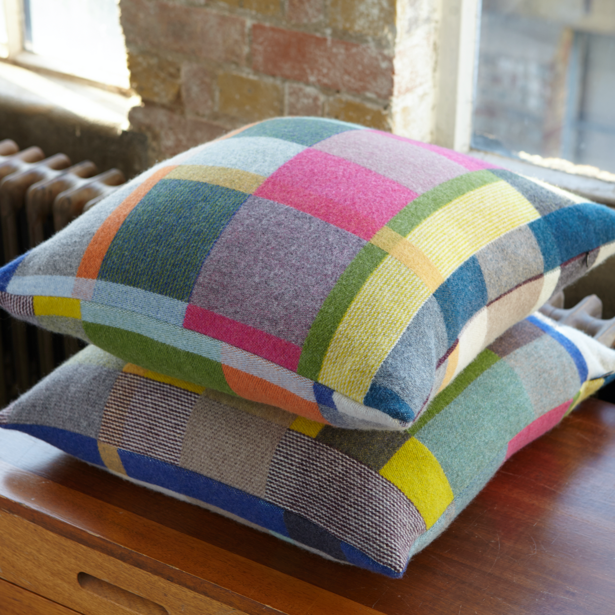 Two Premium Australian Merino Wool Cushion cover - Gwynne, stacked on wood buffet.