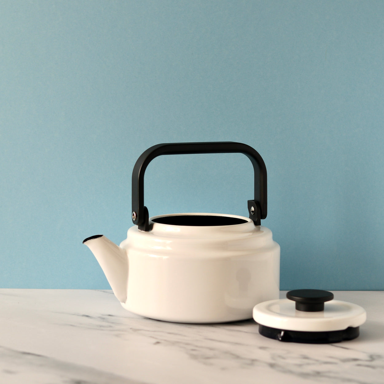 Japanese Noda Horo Amu Kettle - White against pale blue background with lid off