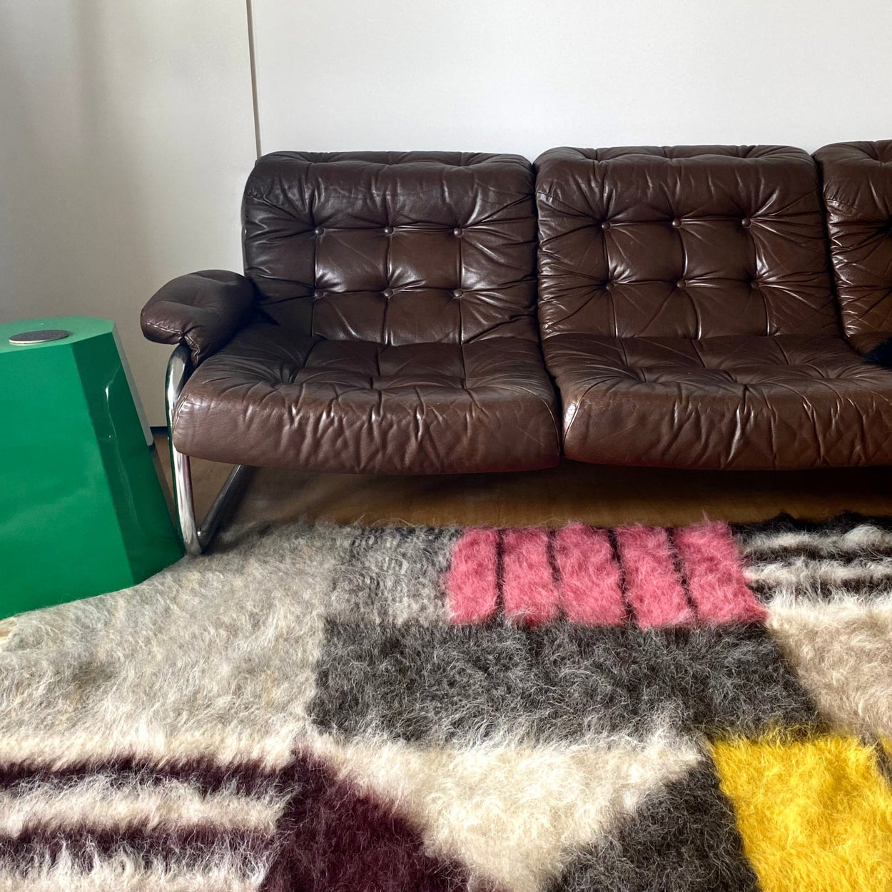 Bauhaus Hand Woven Pure Wool Area Rug with brown leather sofa