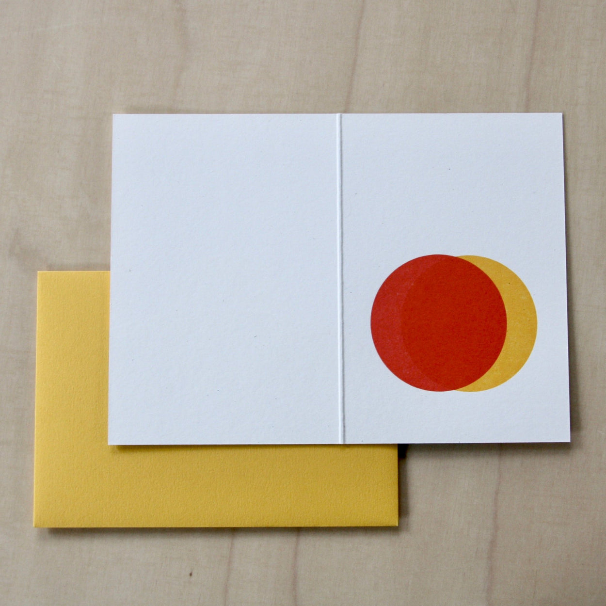 Inside of Hand printed greeting card with yellow and red overlapping suns with a yellow envelope. reading "Three things cannot be long hidden, the sun, the moon and the truth" Buddha