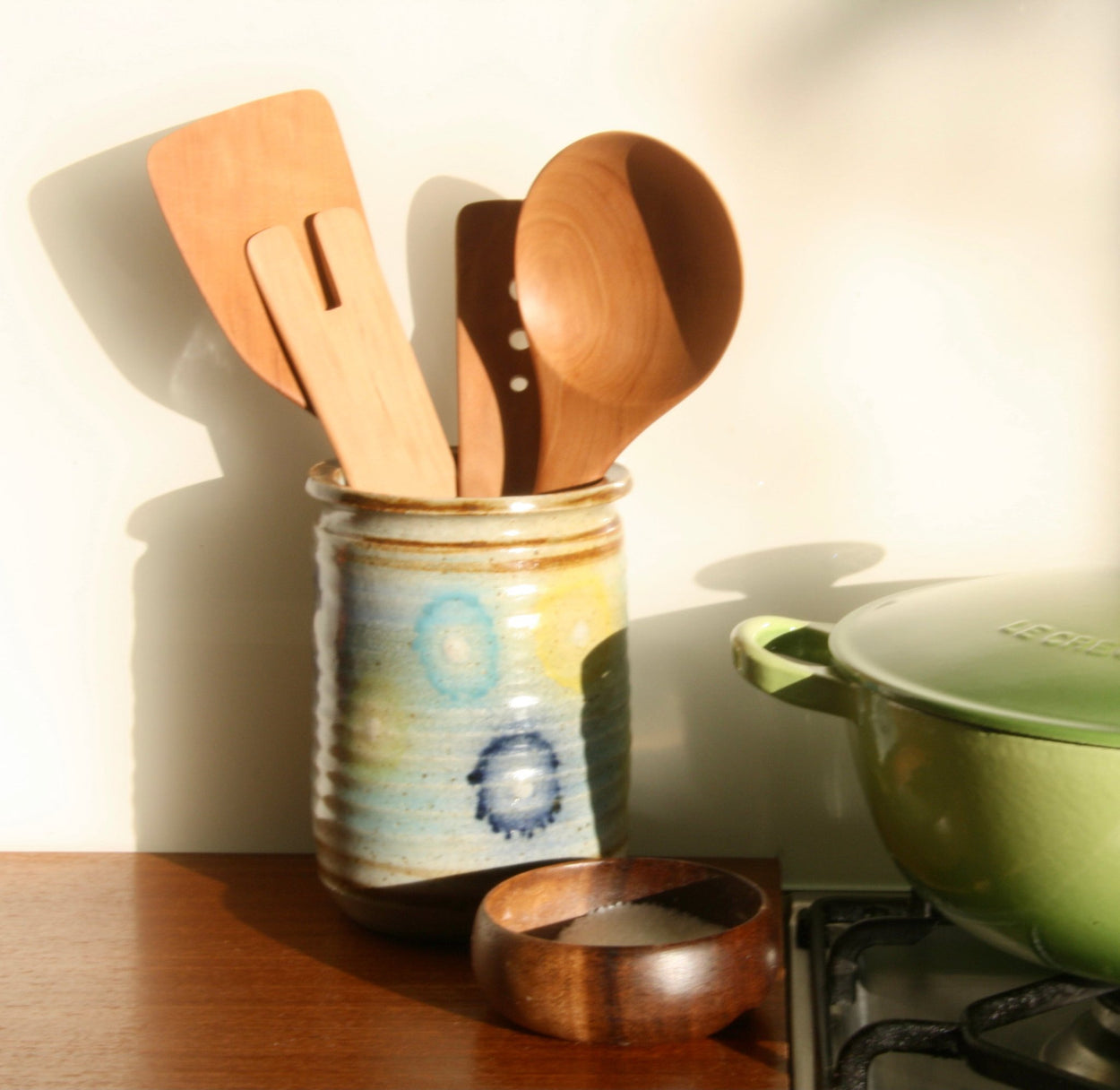 Handmade Pear Wood Salad Servers in ceramic jar with other kitchen utensils