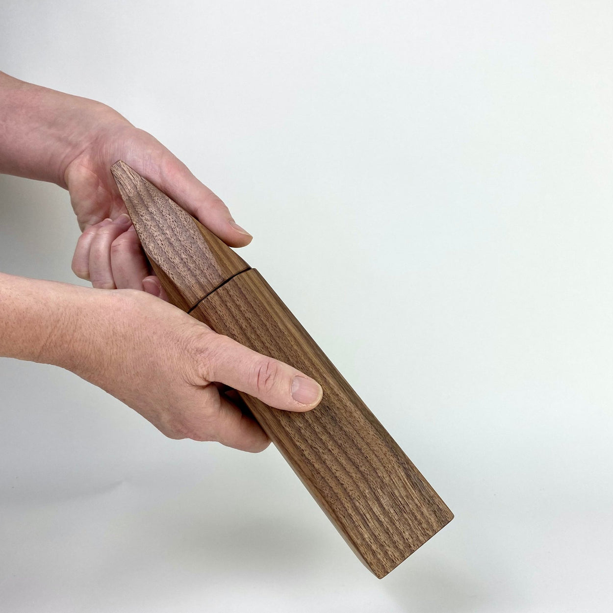 Hand using Walnut Wood Pepper Grinder by Martino Gamper