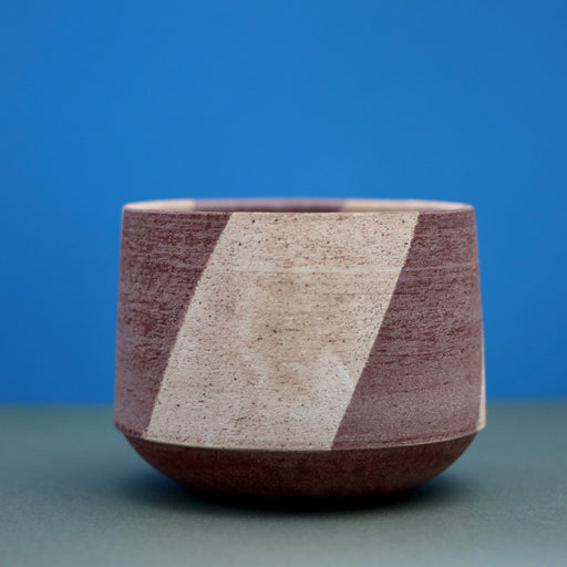 Ceramic Stripe Bowl by Amanda-Sue Rope with blue green background. Close up